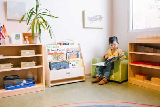 child reading in book corner