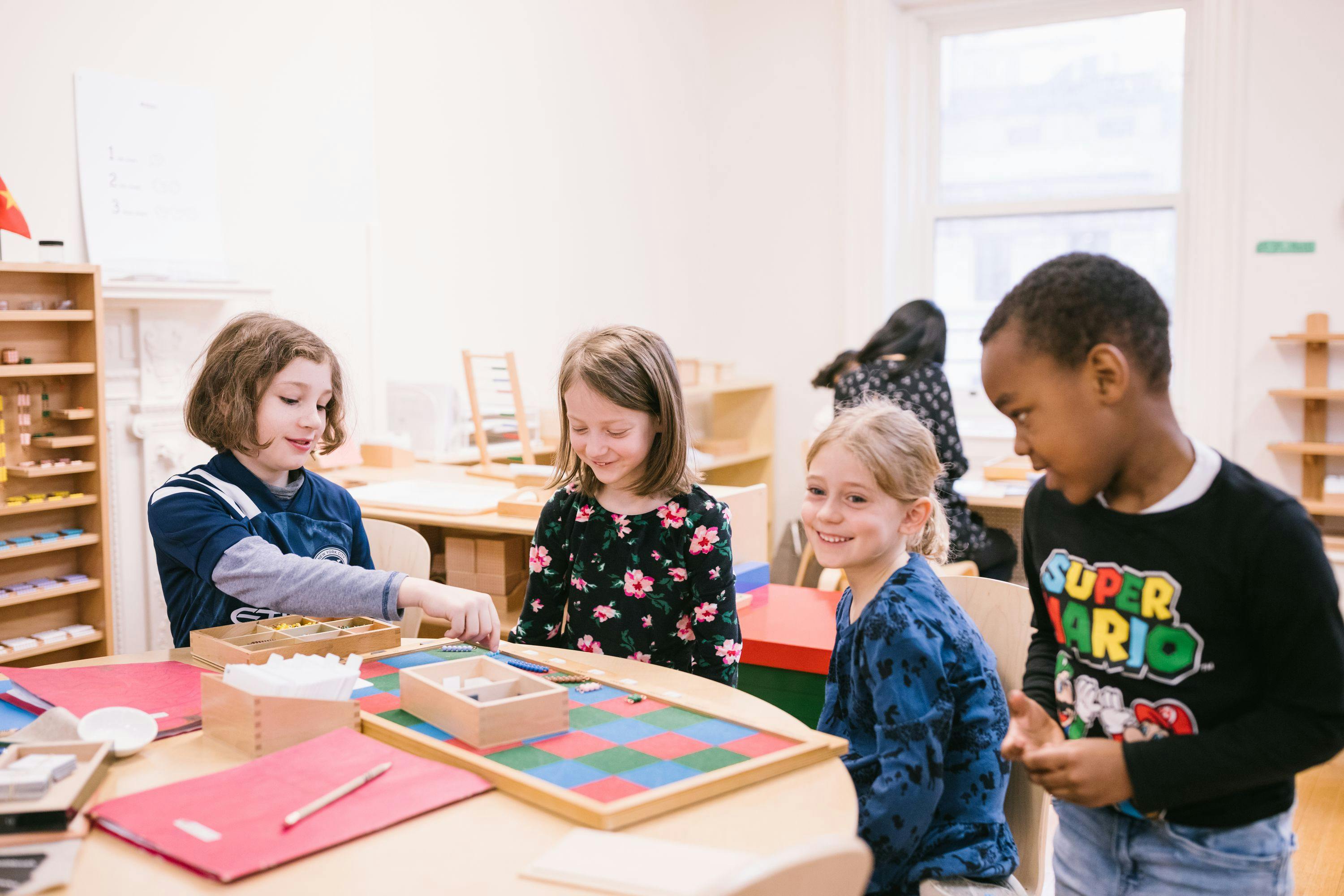 four children in a birmingham guidepost montessori kindergarten classroom