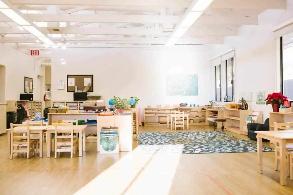 Bright and organized Guidepost Montessori classroom with child-sized furniture and open learning shelves.
