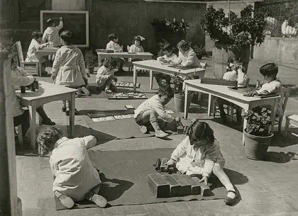 Historic Montessori classroom from the early 1900s showing children working independently, illustrating Maria Montessori’s belief that education answers the question is peace possible.