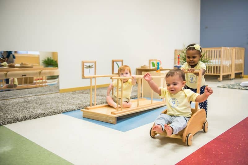 Young children playing with Montessori toys in a classroom setting.