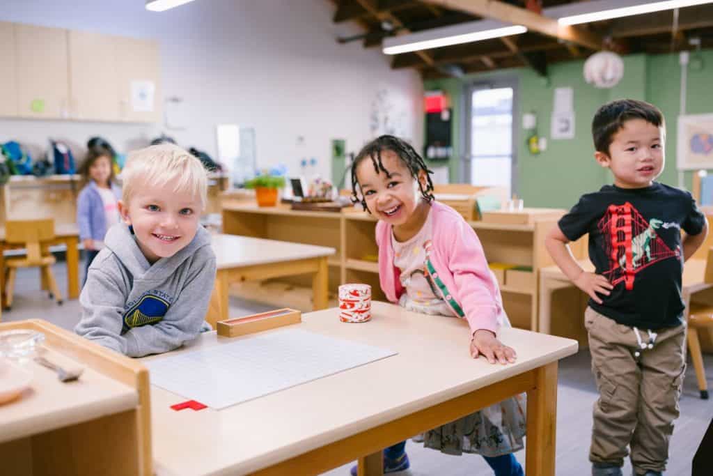 Children engaging in learning activities in a Montessori classroom.
