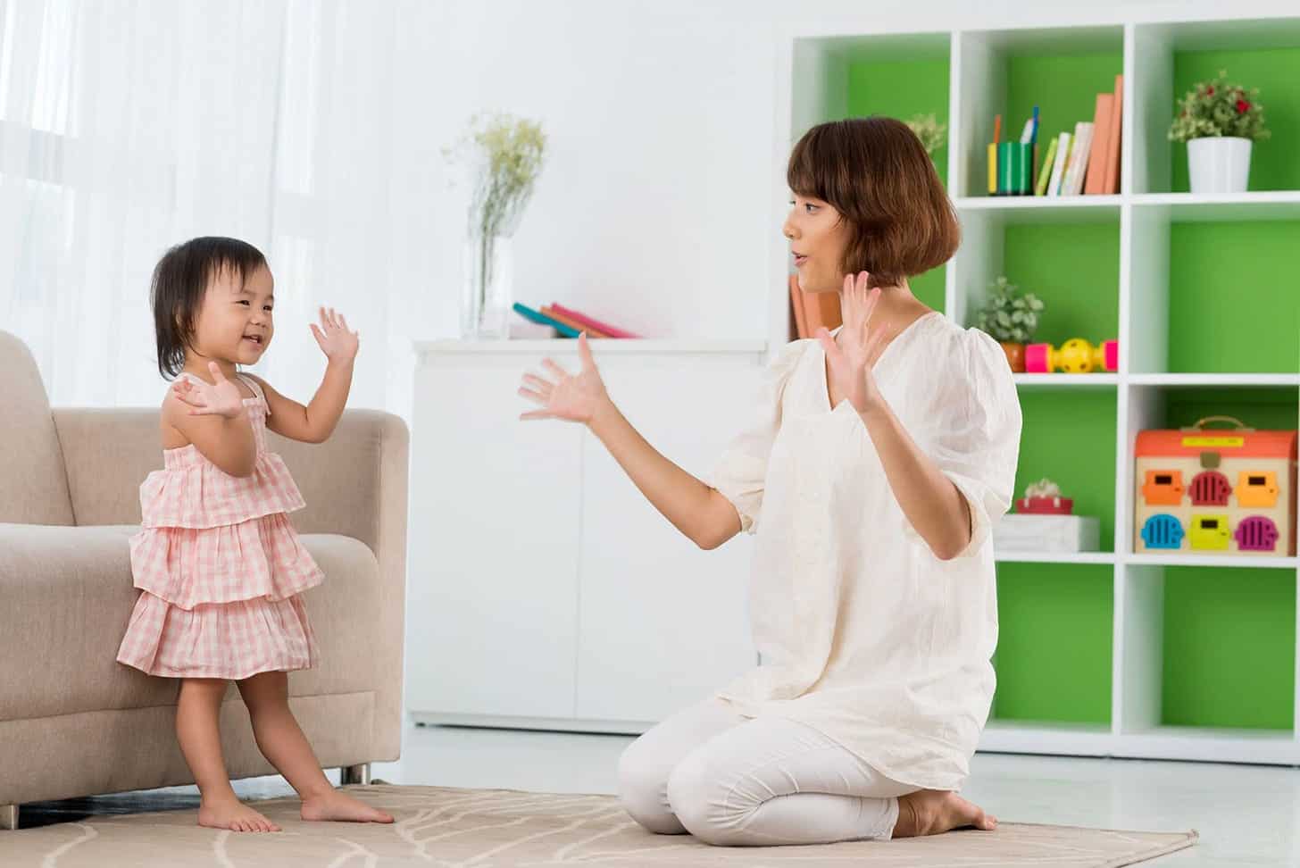Young girl and teacher playing in a colorful Montessori classroom.